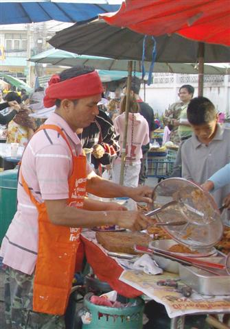 Bangkok fried chicken cooked in a street market stall