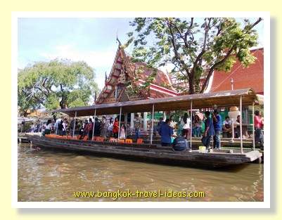 Tour boat outside the temple at Kwan Riam floating market Tour boat outside the temple at Kwan Riam floating market