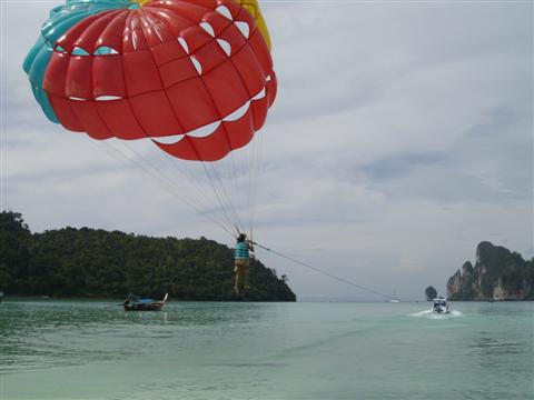 Up up and away. Another brave soul experiences paragliding at the beach on Koh Phi Phi. Up up and away. Another brave soul experiences paragliding at the beach on Koh Phi Phi.